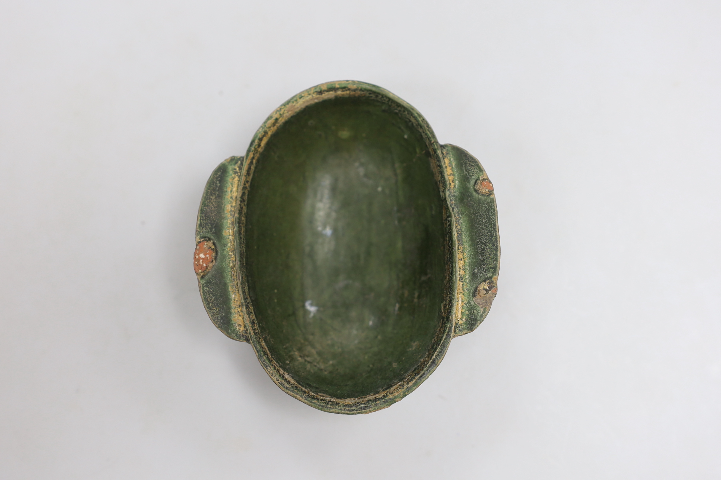 A Chinese Han dynasty green glazed stoneware ear cup, 9cm wide, 10cm long